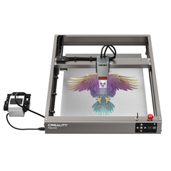 An image of the CrealityFalcon Falcon2 22W Laser Engraver and Cutter Ultimate Engraving Package in operation. The machine is working on a colorful engraving of an eagle with outspread wings on a metal surface. The control module with display is visible on the left side, highlighting its extensive compatibility across various materials.