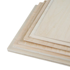 A stack of six CrealityFalcon Basswood Plywood Sheets 11.8" x 11.8" for Laser Engraving - Pack of 10pcs, 6pcs and 3pcs, each slightly smaller than the one below it, ideal for DIY projects. The light-colored boards display visible wood grain patterns and have smooth surfaces and edges. They are neatly arranged, showcasing varied sizes from largest at the bottom to smallest at the top.