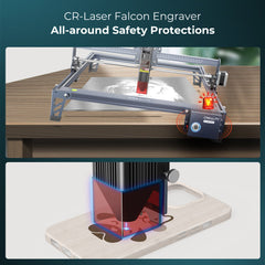 Top image: A CrealityFalcon CR-Laser Falcon 10W Engraver Complete Crafting Engraver Set in use on a wooden table, showcasing its all-around safety protections. Bottom image: Close-up of the high precision laser engraving a design onto the back of a smartphone case.