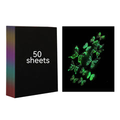 A black stack of 50 A4 Luminous Scratch Paper Fluorescent Scratch for Falcon Laser Engraving sheets from CrealityFalcon is shown on the left. On the right, there are glowing green drawings of various butterflies and leaves on a holographic luminous art paper background.