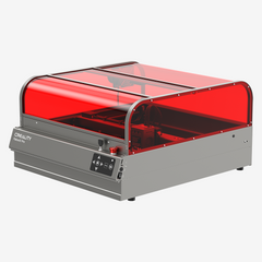 An enclosed laser engraver and cutter with a transparent red cover and a gray base, labeled "CrealityFalcon Falcon2 Pro 60W Enclosed Laser Engraver and Cutter" on the front. The control panel with buttons is located on the front side. The structure appears robust and designed for precise engraving tasks, featuring an intelligent adjustable beam for enhanced precision.