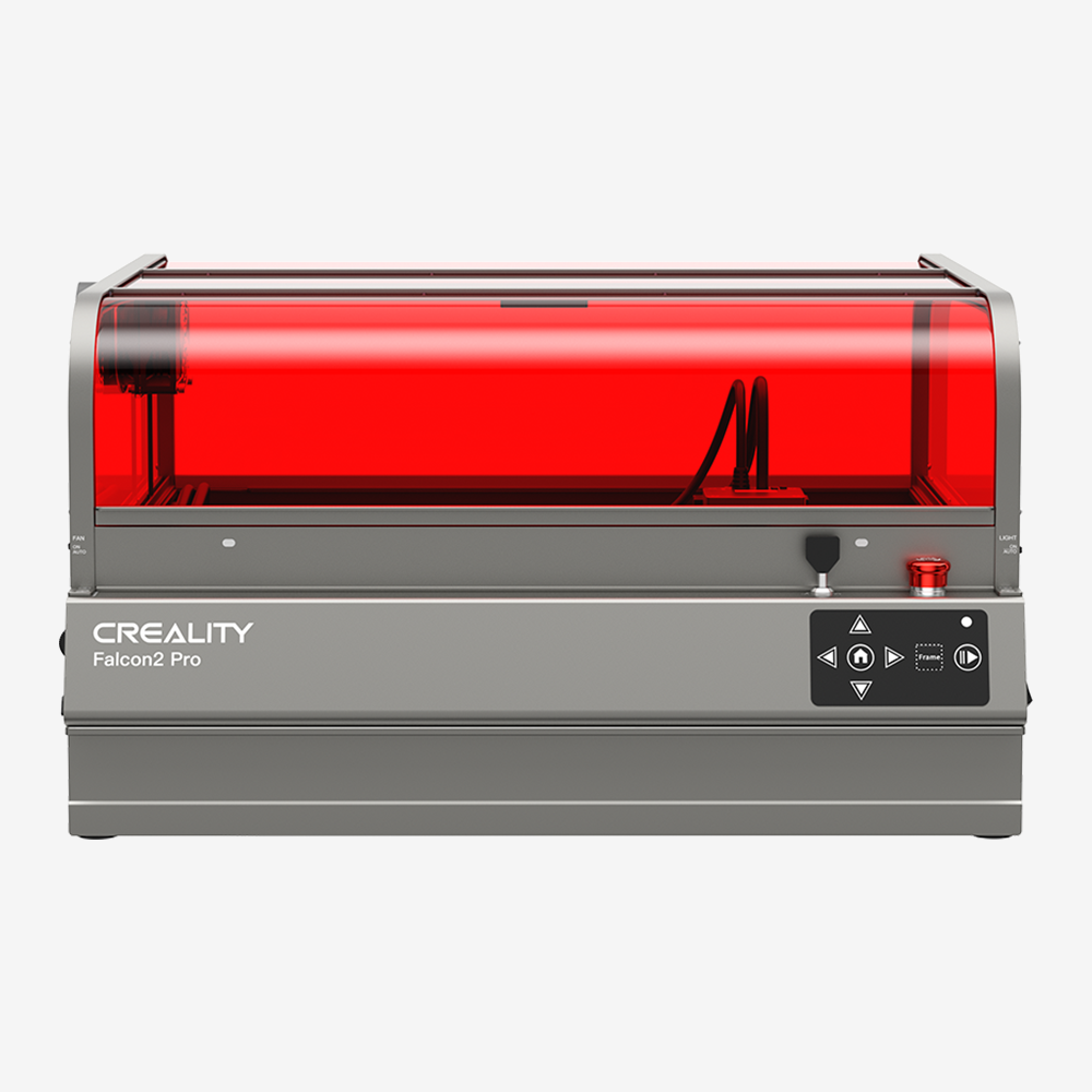 A CrealityFalcon Falcon2 Pro 60W Enclosed Laser Engraver and Cutter with a sleek gray casing and a red-tinted transparent cover. The front features the CrealityFalcon logo, control buttons, and an emergency stop button. This intelligent engraver is designed for professional engraving and cutting tasks, offering an enclosed design for enhanced safety and performance.