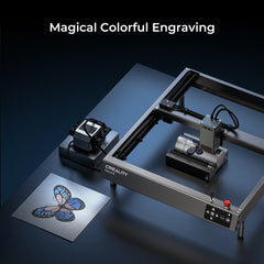 A Falcon2 22W Laser Engraver and Cutter Ultimate Engraving Package by CrealityFalcon is in use, producing a vibrant butterfly design on a metallic surface. The text "Magical Colorful Engraving" is displayed at the top, highlighting the detailed and colorful output of the laser engraving process.